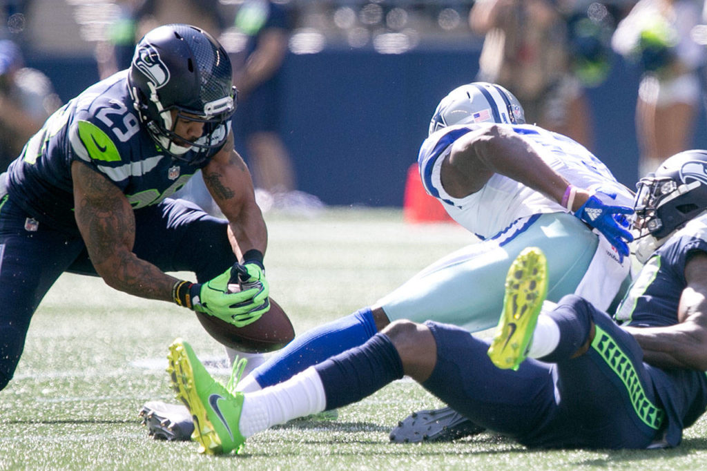 Seahawks Earl Thomas (left) gathers pass intended for Cowboy Michael Gallup for an interception Sunday afternoon at CenturyLink Field in Seattle on September 23, 2018. Seahawks won 24-13. (Kevin Clark / The Herald)
