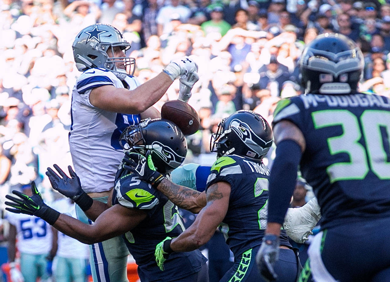 Seahawks Bobby Wagner breaks up a pass intended for Cowboys Blake Jarwin with Seahawks Earl Thomas making an interception Sunday afternoon at CenturyLink Field in Seattle on September 23, 2018. Seahawks won 24-13. (Kevin Clark / The Herald)