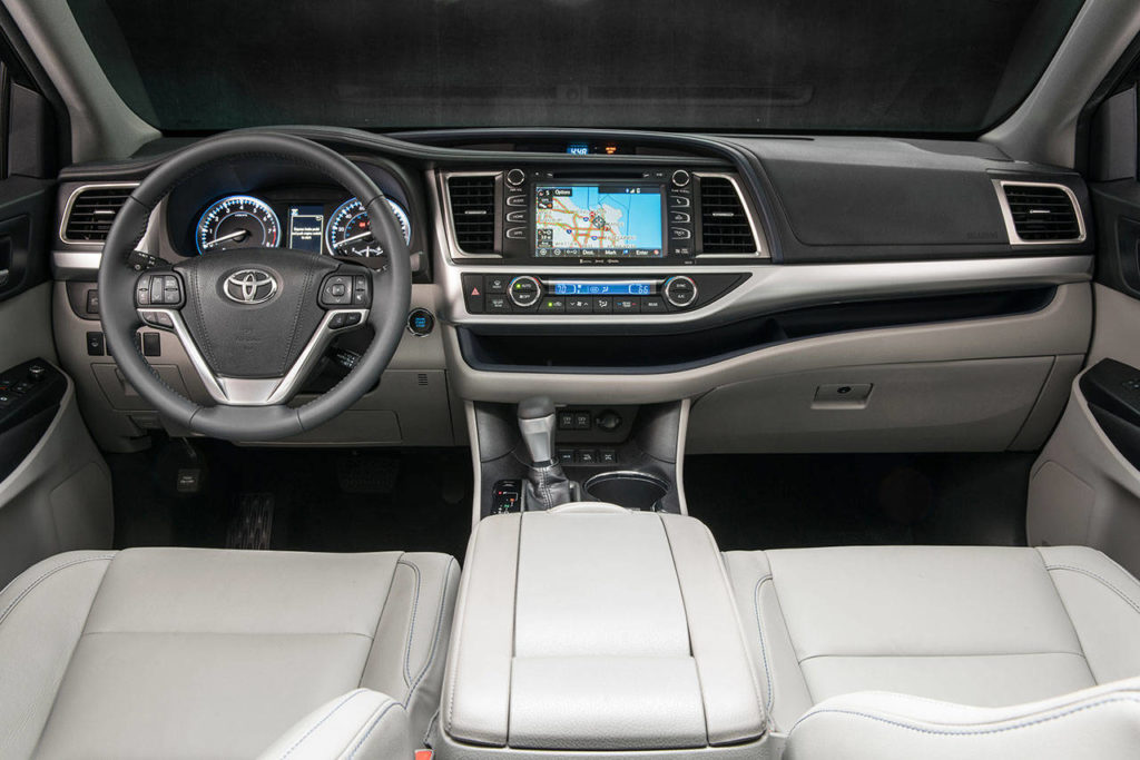 Stowage space inside the 2018 Toyota Highlander midsize SUV includes a handy tray along the lower dash. (Manufacturer photo)
