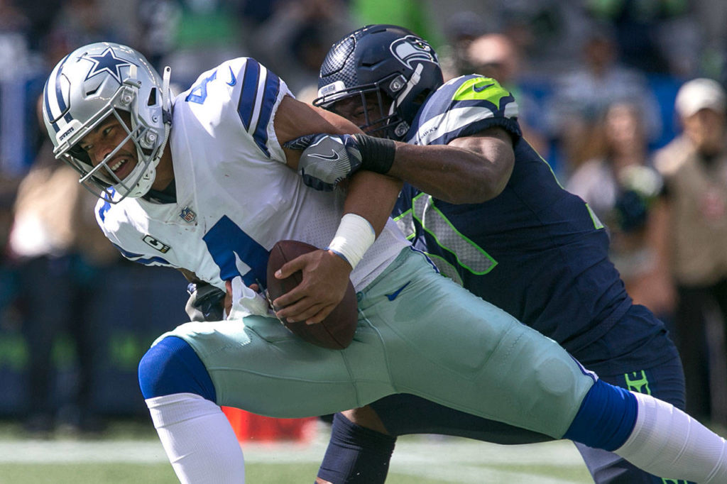 Cowboys Dak Prescott is sacked Seahawks Barkevious Mingo Sunday afternoon at CenturyLink Field in Seattle on September 23, 2018. Seahawks won 24-13. (Kevin Clark / The Herald)
