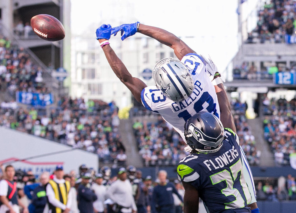 Cowboys Michael Gallup jumps for a overthrown ball with Seahawks Tre Flowers defending Sunday afternoon at CenturyLink Field in Seattle on September 23, 2018. Seahawks won 24-13. (Kevin Clark / The Herald)
