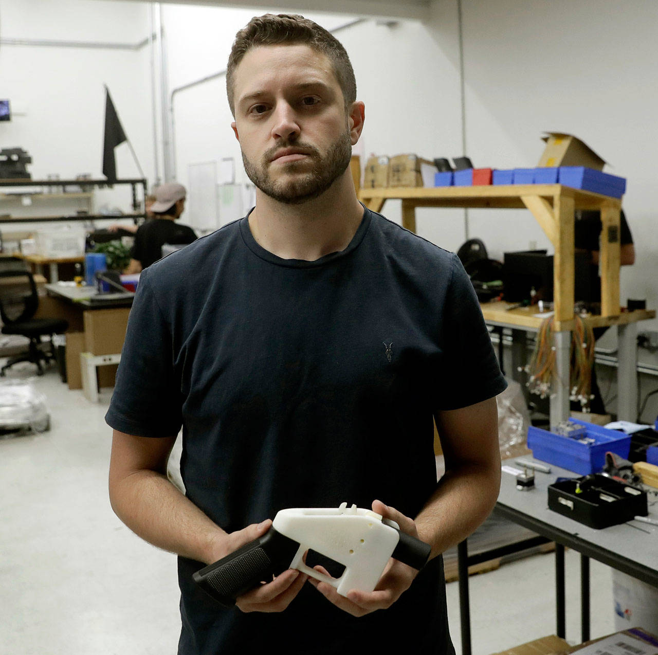 Cody Wilson, with Defense Distributed, holds a 3D-printed gun called the Liberator at his shop in Austin, Texas. (AP Photo/Eric Gay, File)