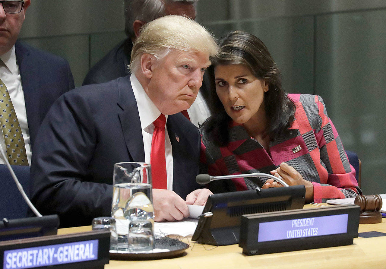 President Donald Trump talks to Nikki Haley, the U.S. ambassador to the United Nations, at the United Nations General Assembly on Monday. (AP Photo/Evan Vucci)