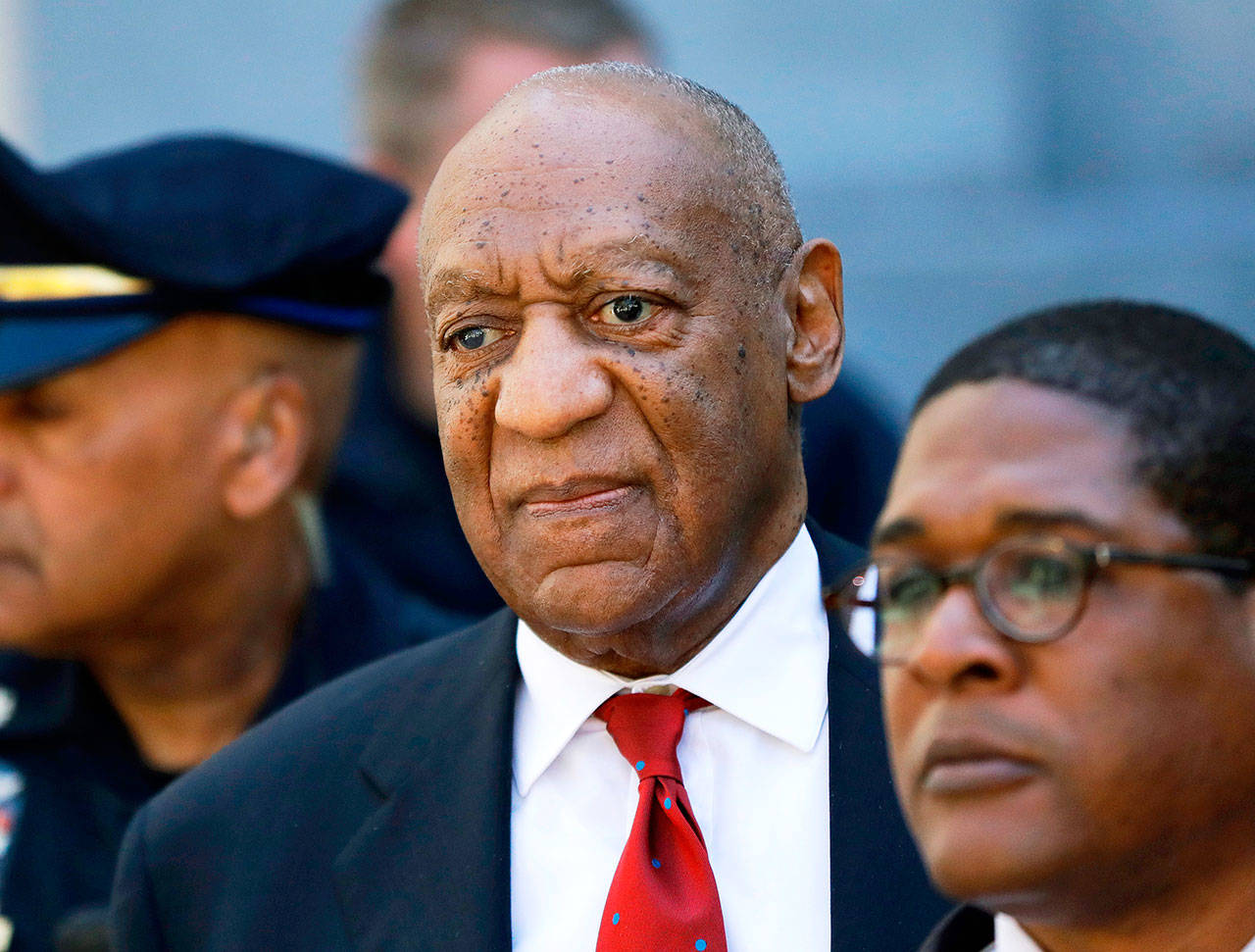 Bill Cosby (center) leaves the Montgomery County Courthouse in Norristown, Pennsylvania, last April. (AP Photo/Matt Slocum, File)