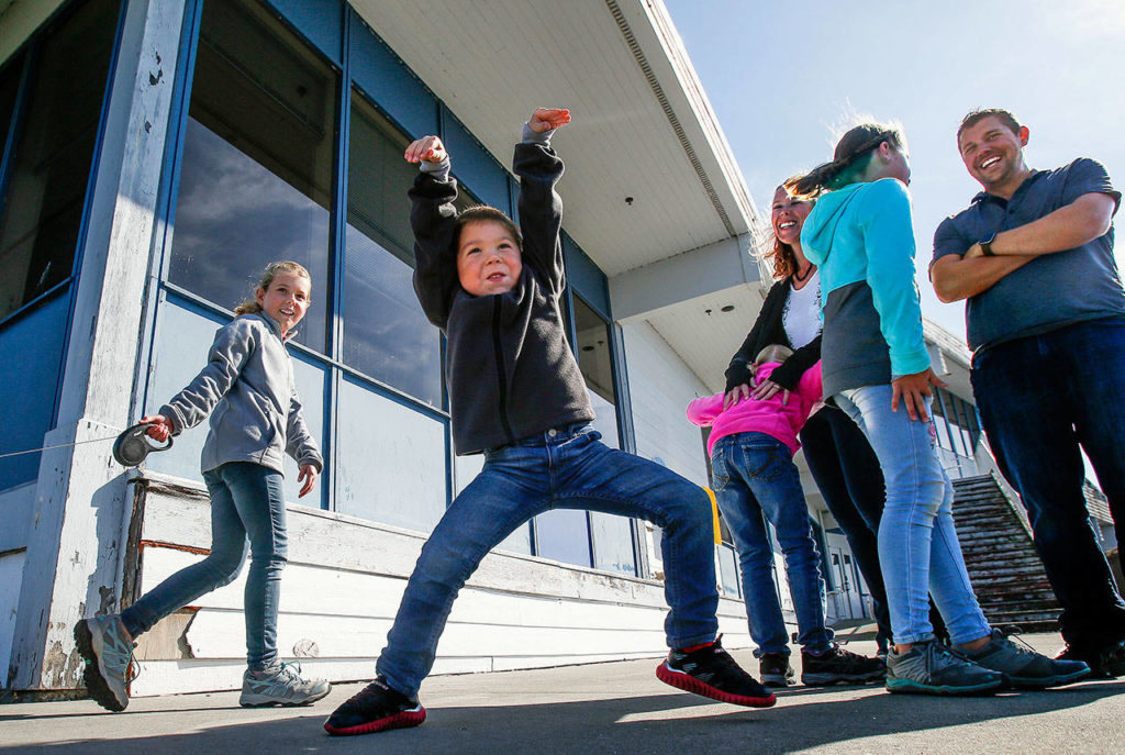 To the delight of the rest of his family, Caleb, 4, spontaneously begins to dance while on a walk near the Everett Yacht Club. He’ll turn 5 on Monday. (Dan Bates / The Herald)
