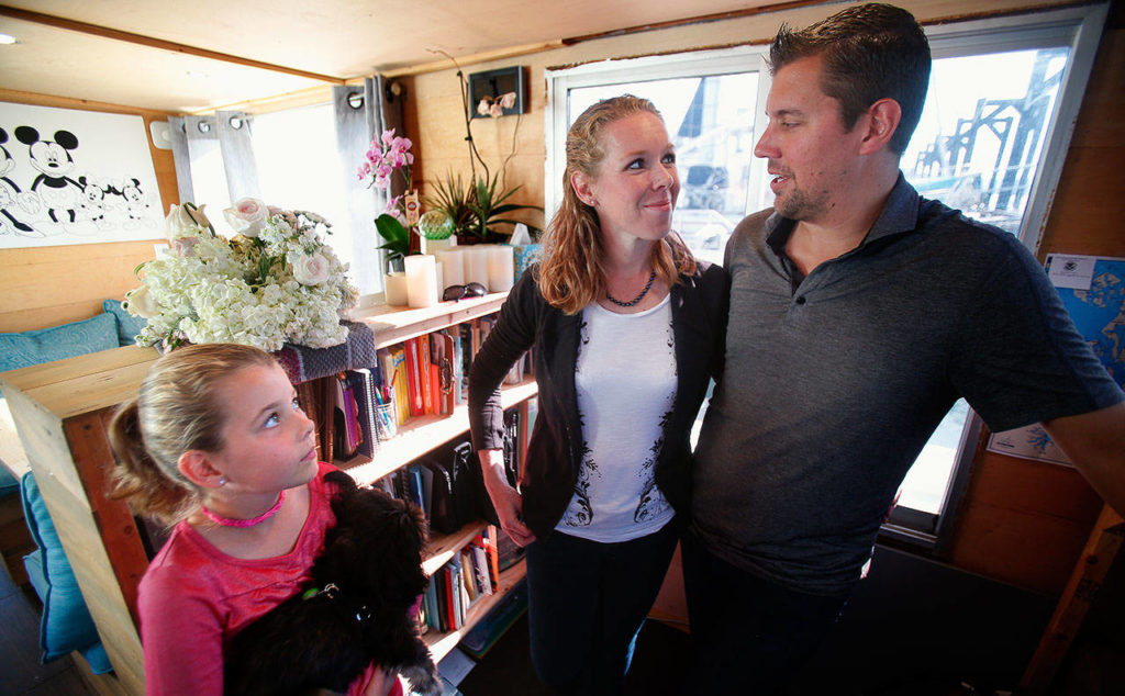 In the family’s school, next to the general living, eating and playing area, the Taiseys have a nice library with good light. Arianna, 10, listens while Ryan and Jacy talk about homeschooling and their faith. (Dan Bates / The Herald)
