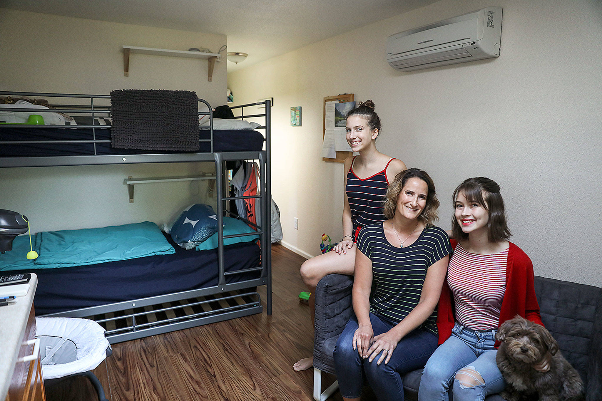 Christa Johnson (middle) along with her daughters Anna (right), Colette (left) and her husband Todd (not pictured) host families experiencing homelessness in a remodeled building on their property. The unit allows the Interfairth Family Shelter to house one more family without shelter. (Lizz Giordano / The Herald)