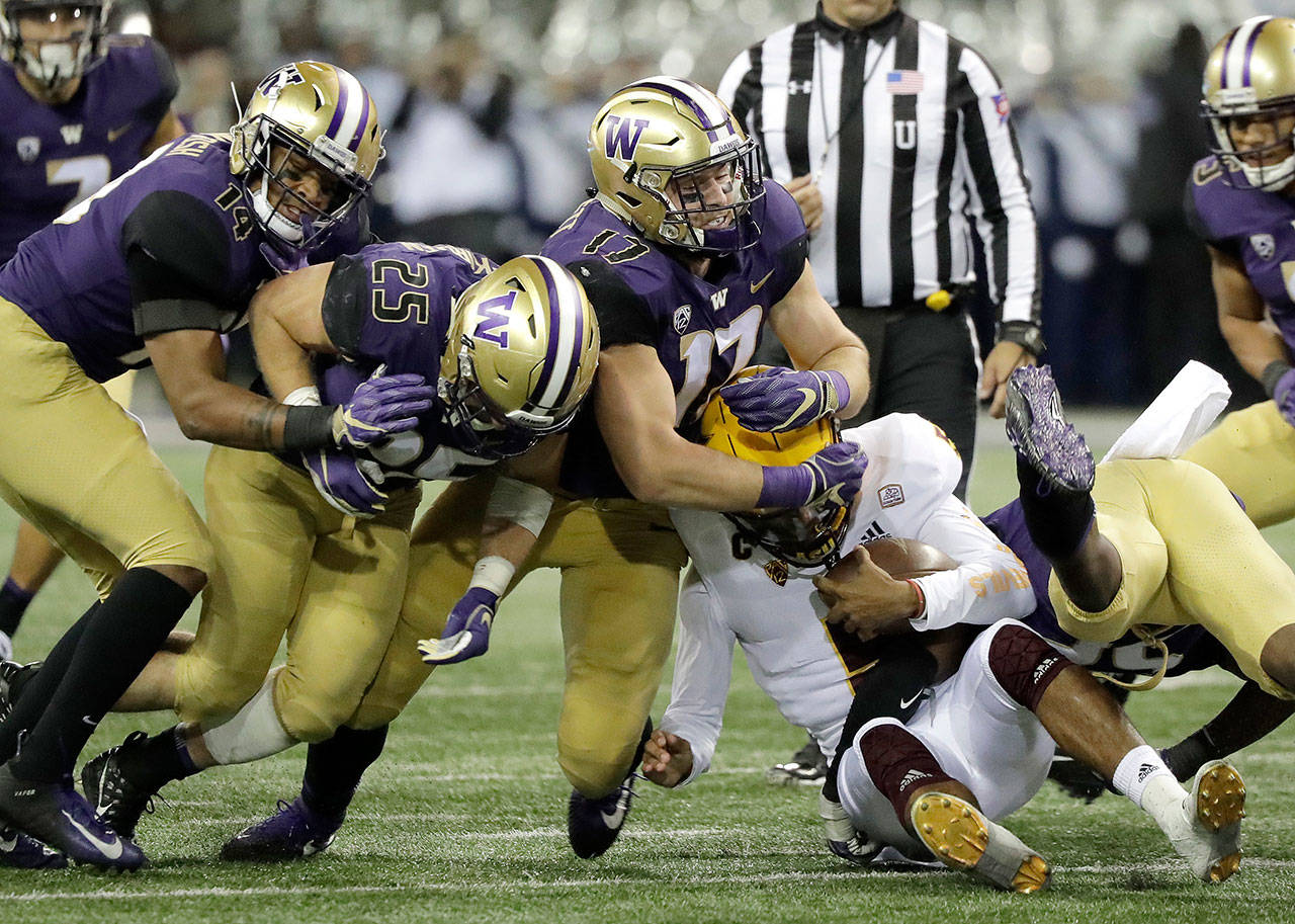 Arizona State quarterback Manny Wilkins is wrapped up by Washington linebacker Tevis Bartlett (17) in the first half of Saturday’s game at Husky Stadium in Seattle, which was won by UW 27-20. Wilkins found it tough sledding to get much going through the air against the vaunted Washington secondary. (AP Photo/Ted S. Warren)