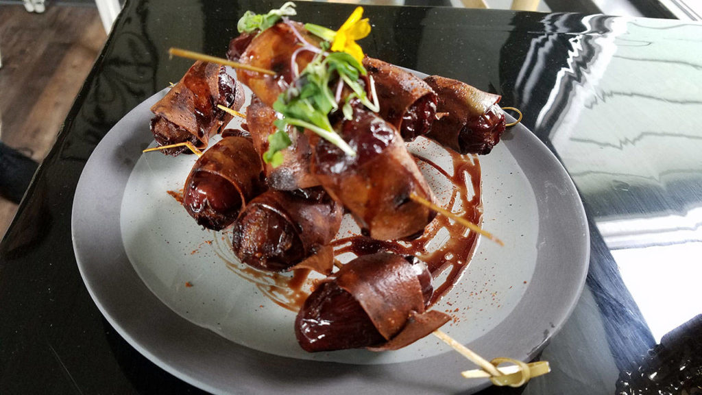 The cashew blue cheese stuffed dates wrapped with vegan prosciutto is part of menu aimed at being approachable to non-vegans. (Sharon Salyer / The Herald)
