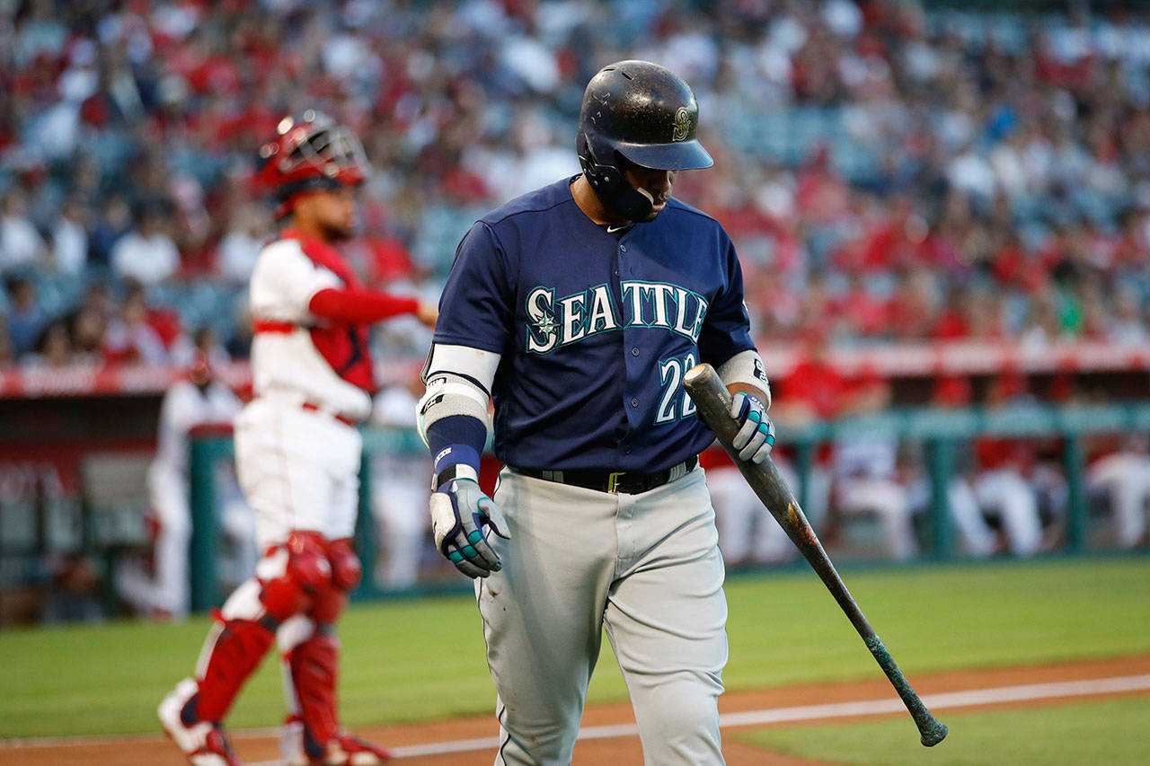 The Mariners’ Robinson Cano walks off the field after striking out during the first inning of a game against the Angels on Sept. 15, 2018, in Anaheim, Calif. (AP Photo/Jae C. Hong)