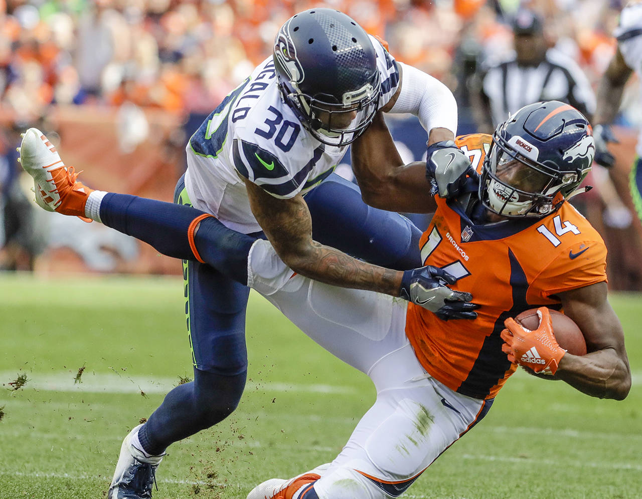 Denver Broncos wide receiver Courtland Sutton (14) is tackled by Seattle Seahawks defensive back Bradley McDougald (30) during the second half of an NFL football game on Sept. 9 in Denver. (AP Photo/Jack Dempsey, file)