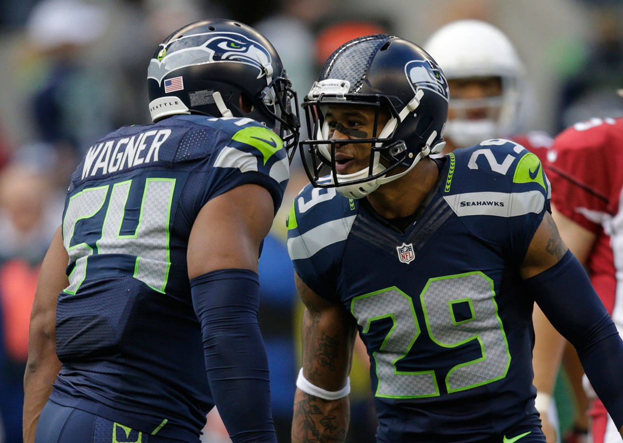 Seahawks safety Earl Thomas (29) and middle linebacker Bobby Wagner react after a play against the Arizona Cardinals during a game in Seattle in 2014. (AP Photo/Stephen Brashear)