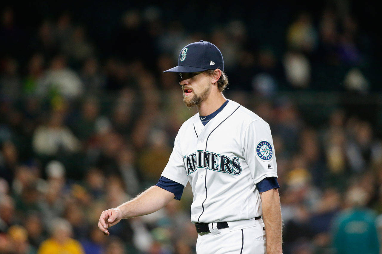 Seattle’s Mike Leake walks back to the dugout in the second inning after being pulled from Tuesday’s game at Safeco Field. (AP Photo/Jennifer Buchanan)