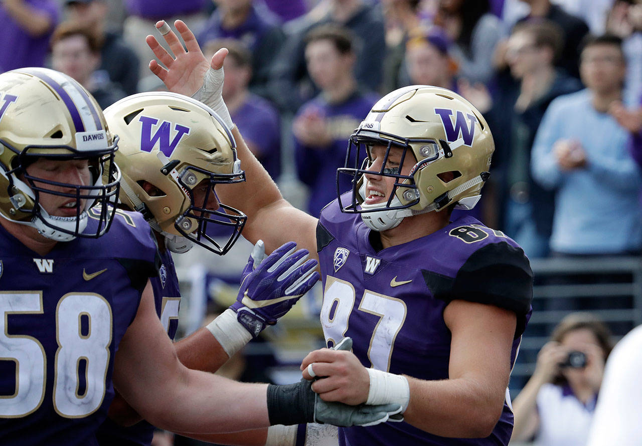 Washington’s Cade Otton (87) is congratulated after scoring against North Dakota in the second half of a game Sept. 8, 2018, in Seattle. (AP Photo/Elaine Thompson)