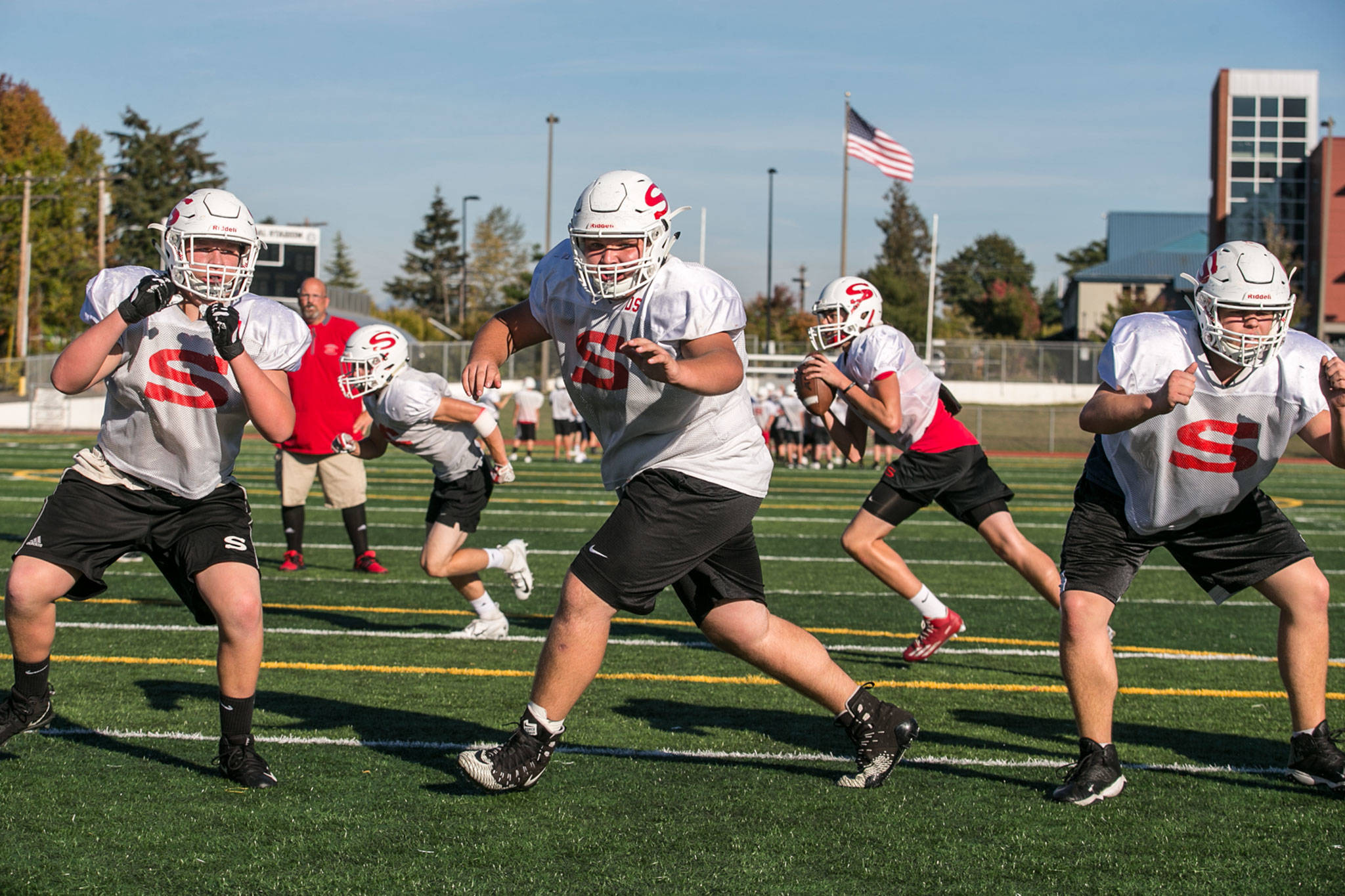 Members of the Snohomish football team’s offensive line practice a play Thursday at Veterans Memorial Stadium (Kevin Clark / The Herald)