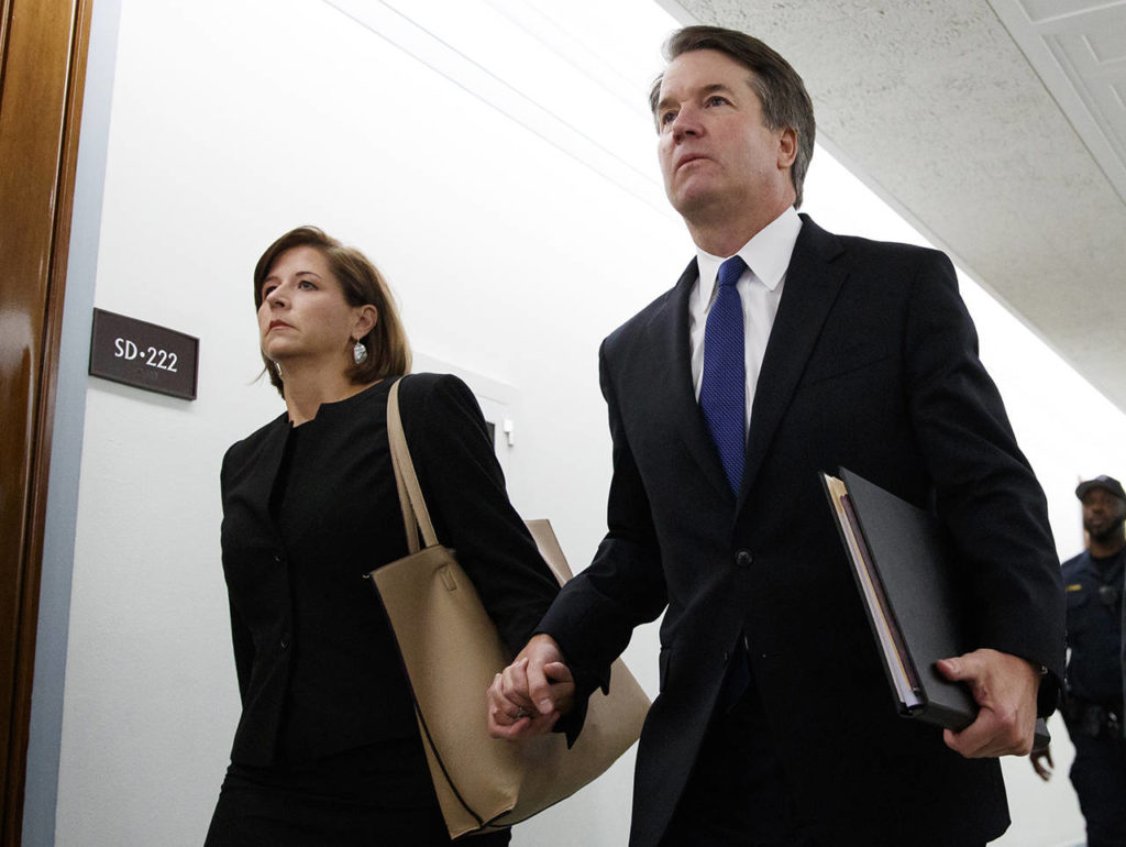 Brett Kavanaugh and his wife, Ashley Estes Kavanaugh, hold hands as they arrive for a Senate Judiciary Committee hearing on Capitol Hill in Washington on Thursday. (AP Photo/Carolyn Kaster)
