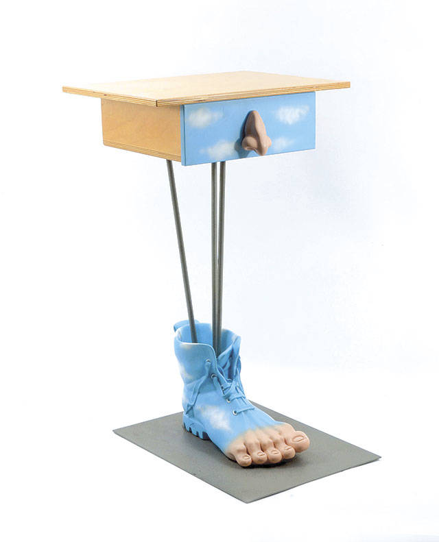 A blue boot covers the large resin “foot” that is the base of a 25-inch-high table, which sold for only $175. It’s a conversation piece for a quirky home. (Cowles Syndicate Inc.)