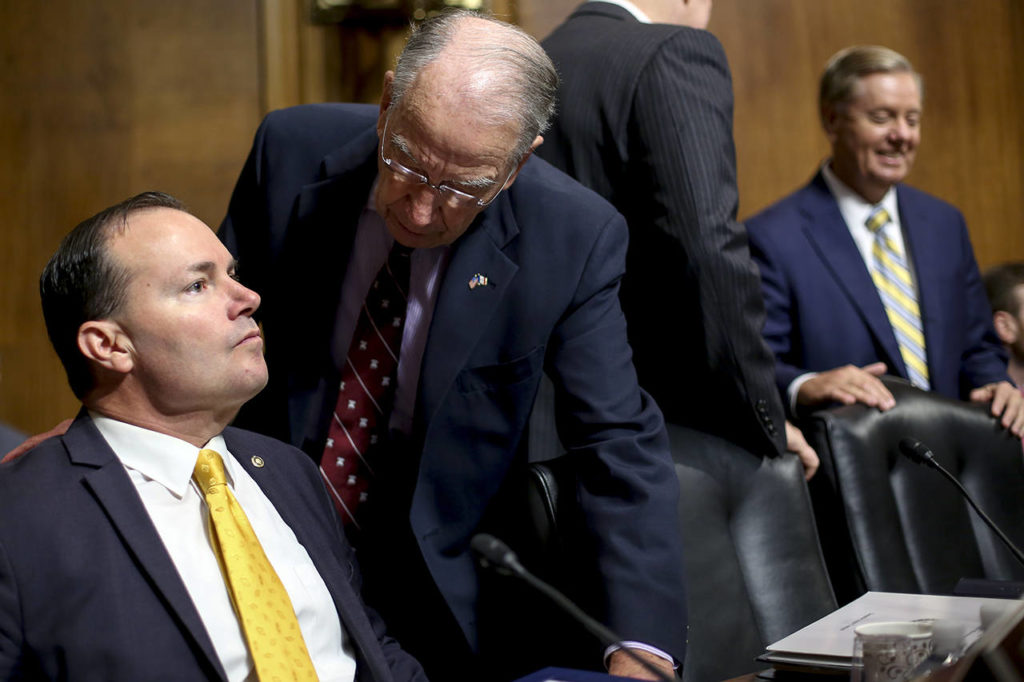Senate Judiciary Committee Chairman Chuck Grassley of Iowa (second from left) speaks with Sen. Mike Lee, R-Utah (left), before a meeting of the committee Friday on Capitol Hill in Washington. (AP Photo/Pablo Martinez Monsivais)
