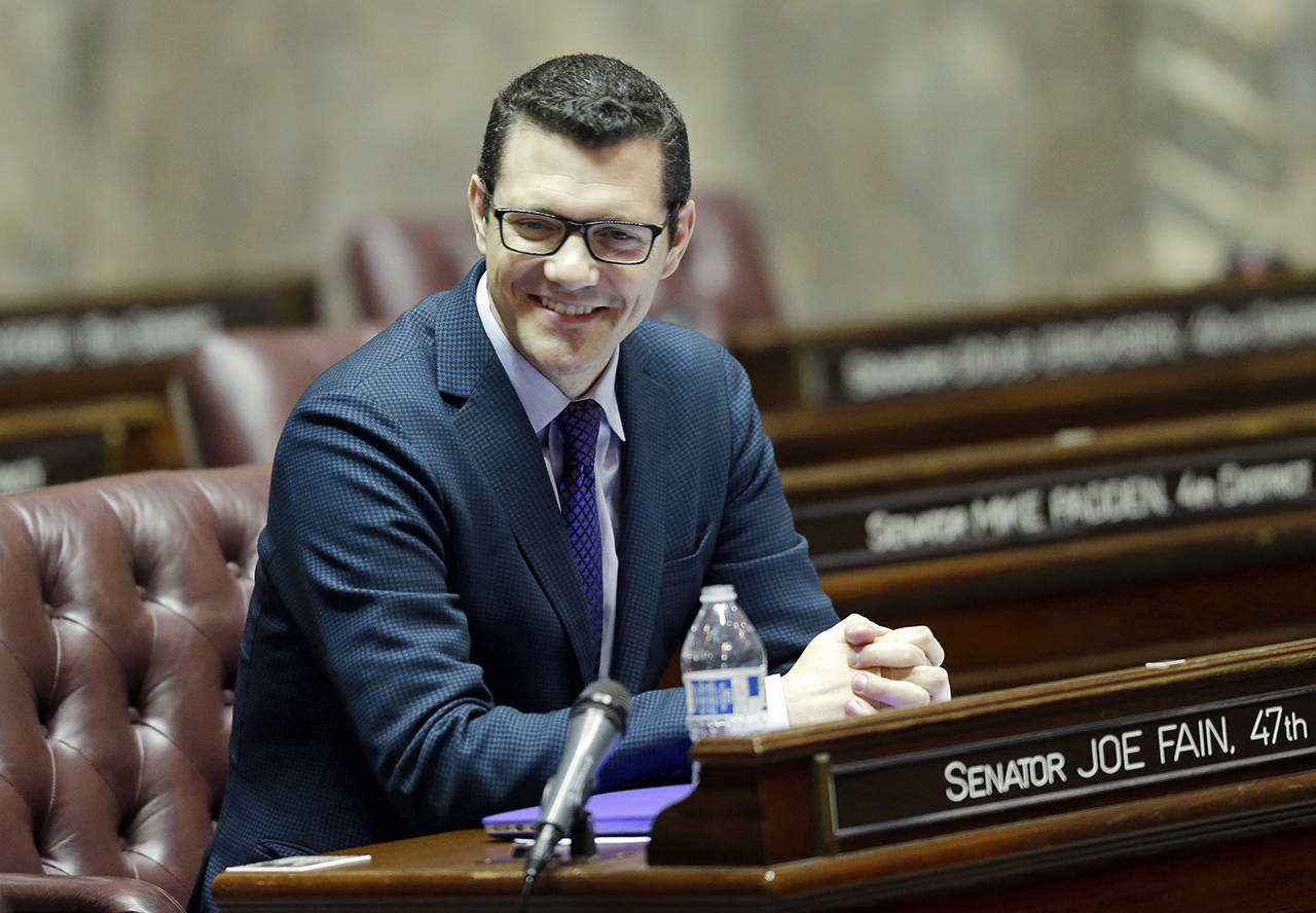 In this 2017 photo, Senate Republican floor leader Joe Fain, R-Auburn, sits at his desk on the Senate floor in Olympia. (AP Photo/Ted S. Warren, file)