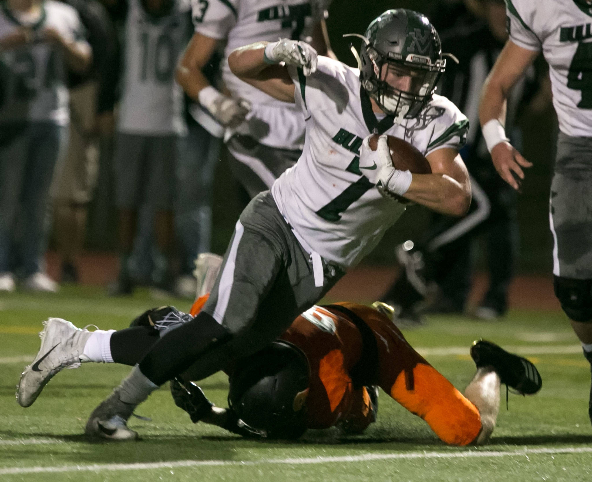 Mount Vernon’s Seth Tercero crosses the goal line past a tackle attempt by Monroe’s Austin Moyes during a game on Sept. 28, 2018, at Monroe High School. (Kevin Clark / The Herald)