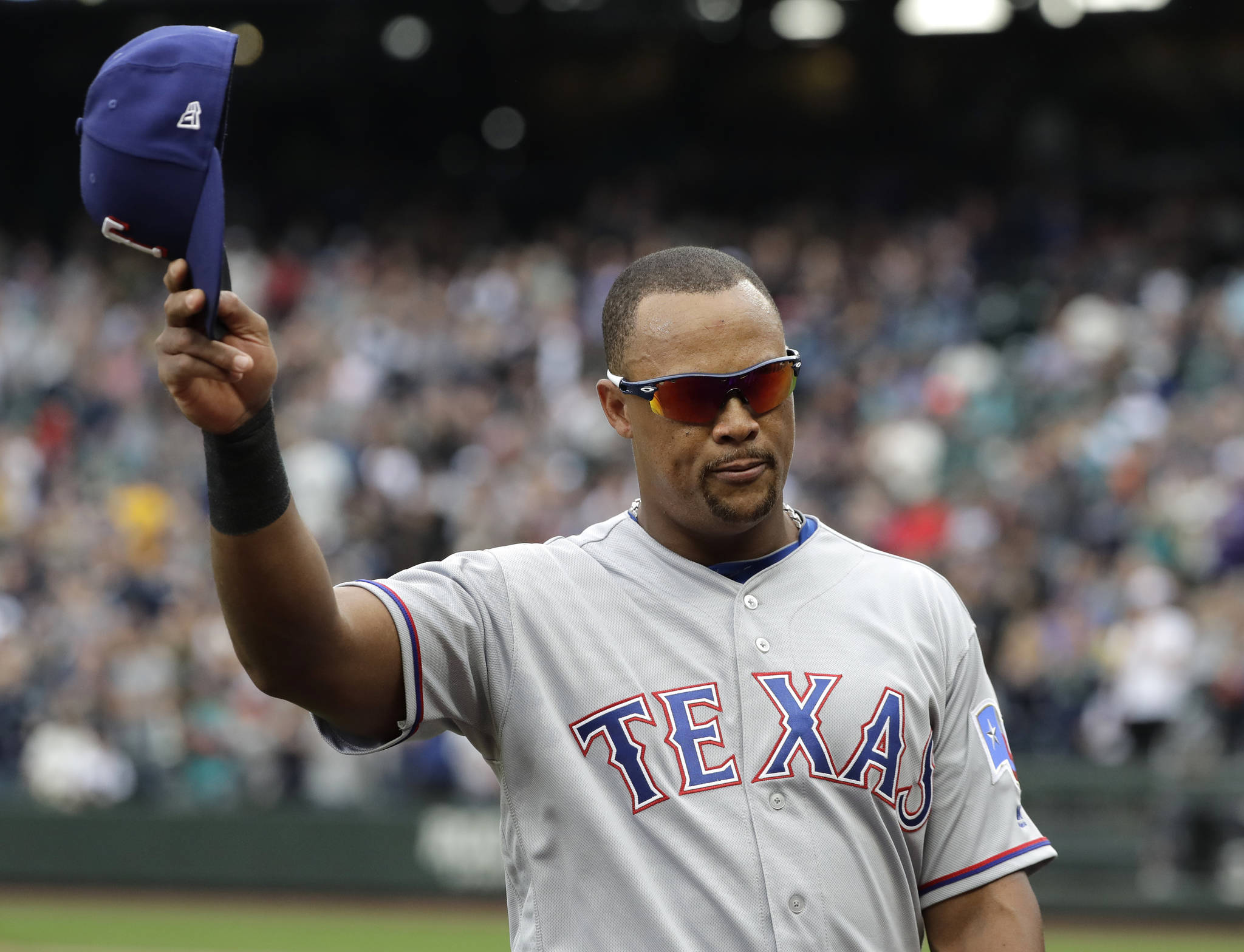 Adrian Beltre of the Texas Rangers tips his cap as he walks off the field during the fifth inning of Sunday’s game at Safeco Field in Seattle. (AP Photo/Ted S. Warren)