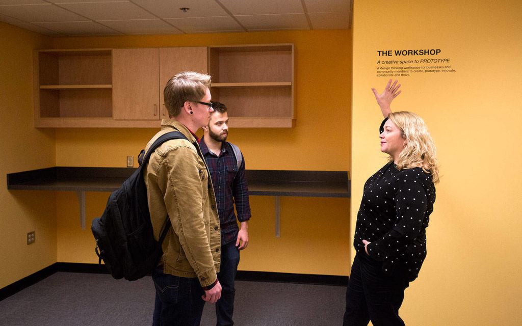 Program Director Lara Merriam-Smith of the Northwest Innovation Resource Center gives interns Kaleb Weber (left) and Austin Treherne a tour of TheLab@everettt. (Andy Bronson / The Herald)
