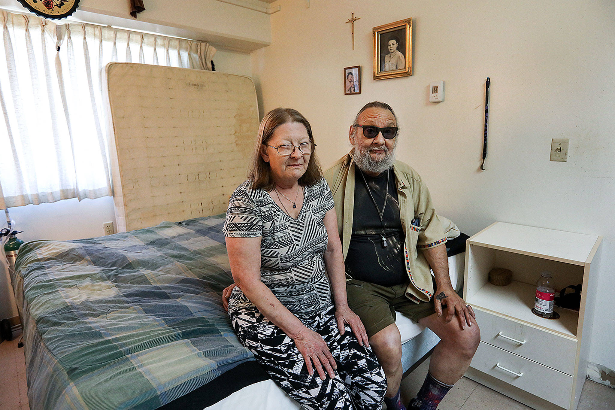 Lynn All (left) and Richard Flores first noticed the bedbugs in their Broadway Plaza apartment in February. Due to the infestation, the couple says they need to throw away many of their belongings, including the mattress pictured in the background. (Lizz Giordano / The Herald)