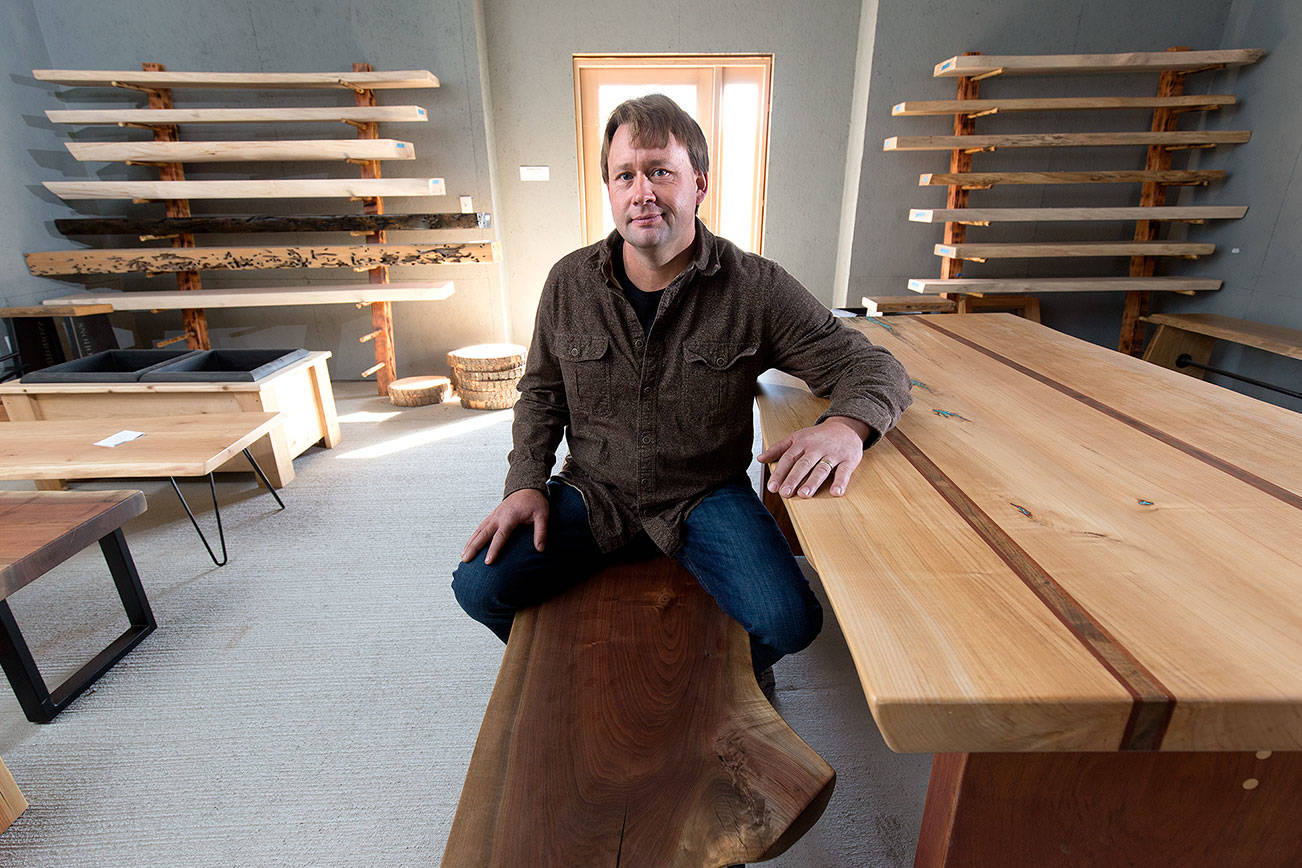 Kevin Stormo, owner of Stormo Hardwoods, in the showroom at 2730 Broadway on Monday, Sept. 24, 2018 in Everett, Wa. His company creates “live edge” furniture from kiln-dried tree slabs. (Andy Bronson / The Herald)
