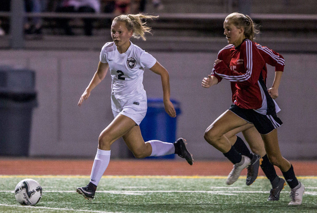 Cedarcrest’s Piper Parish (left) dribbles away from two Snohomish defenders during a game on Sept. 25, 2018, in Snohomish. (Olivia Vanni / The Herald)
