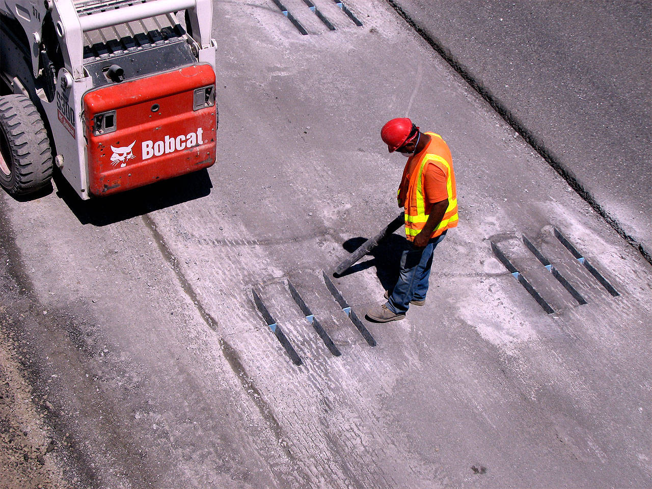 This photo from the Washington State Department of Transportation shows how dowel bars are installed to help connect and reinforce concrete road panels. (WSDOT photo)