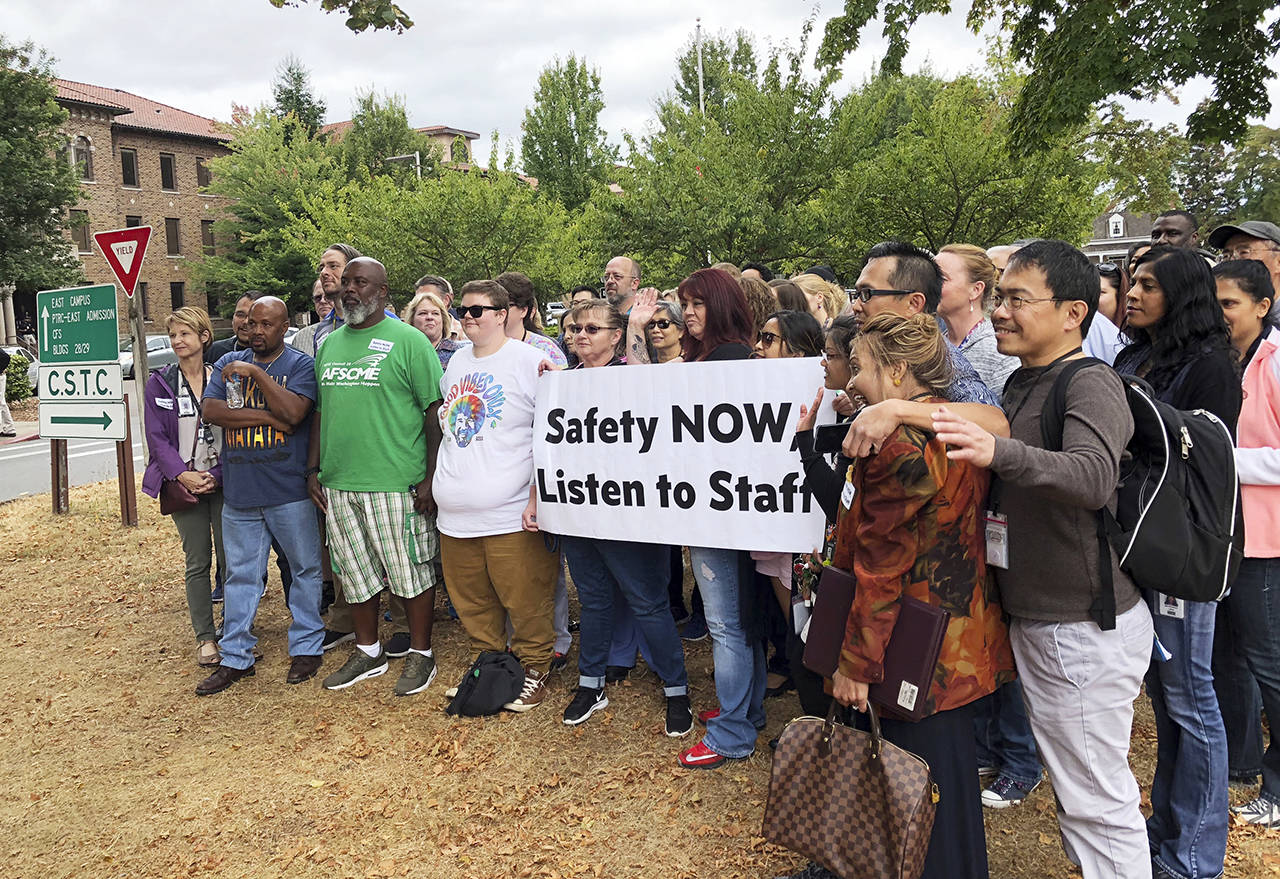 In this Aug. 30 photo, workers rally demanding changes to the way officials assign dangerous patients to wards at Western State Hospital in Lakewood. (AP Photo/Martha Bellisle, File)