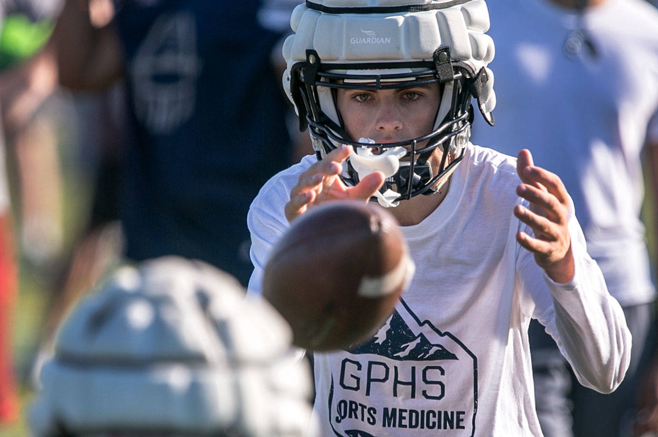 Ayden Ziomas takes a snap Thursday during a practice session in Snohomish. (Kevin Clark / The Herald)