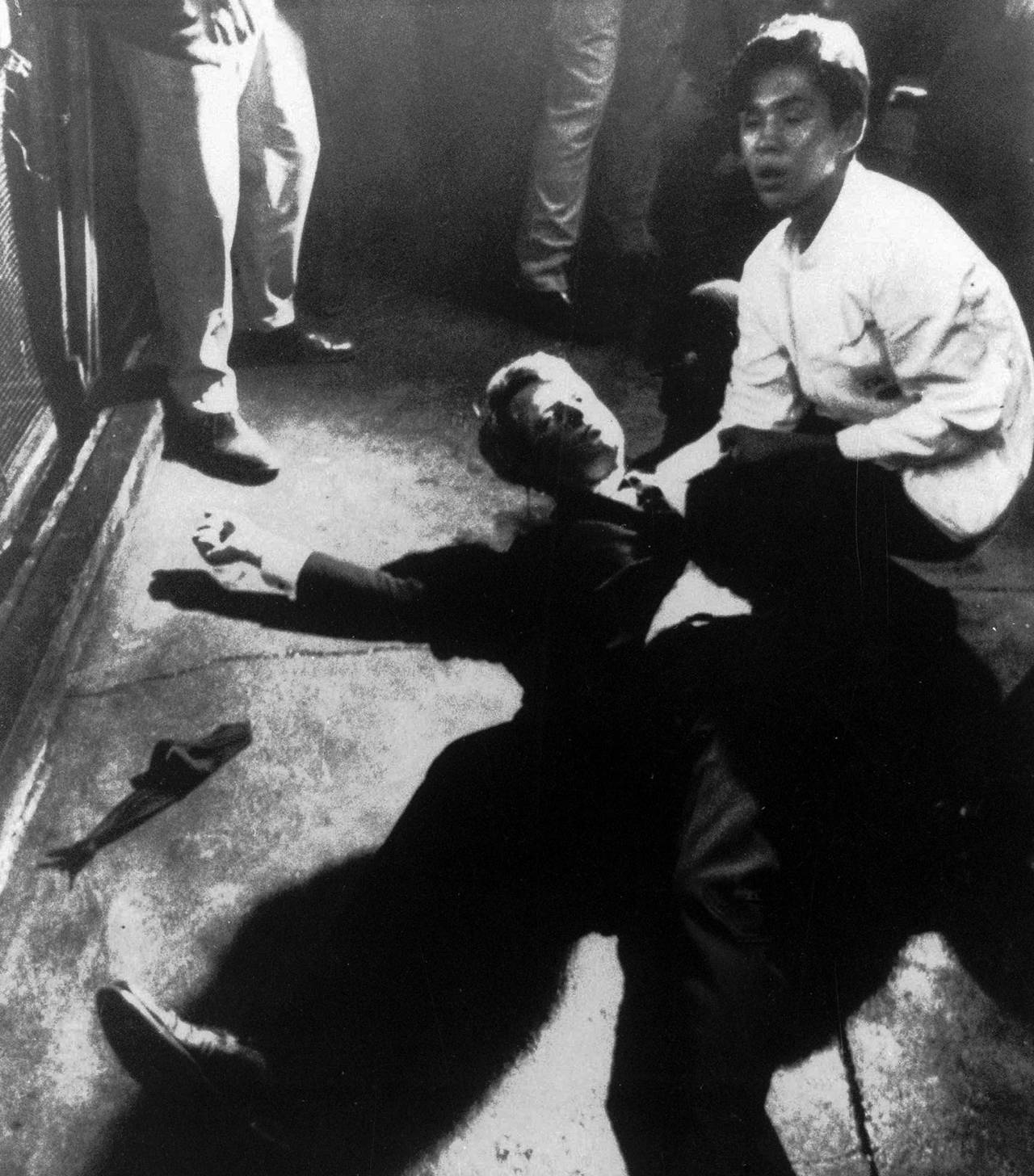 In this June 5, 1968 photo, Hotel busboy Juan Romero (right) comes to the aid of Senator Robert F. Kennedy as he lies on the floor of the Ambassador hotel in Los Angeles moments after he was shot. The Los Angeles Times reported that Romero died Monday in Modesto, California, at age 68. (Boris Yaro/Los Angeles Times via AP, file)