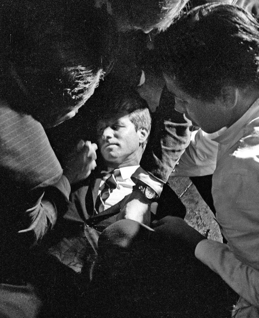 In this June 5, 1968 photo, Hotel busboy Juan Romero (right) comes to the aid of Senator Robert F. Kennedy as he lies on the floor of the Ambassador hotel in Los Angeles moments after he was shot. (Richard Drew/Pasadena Star News via AP, file)
