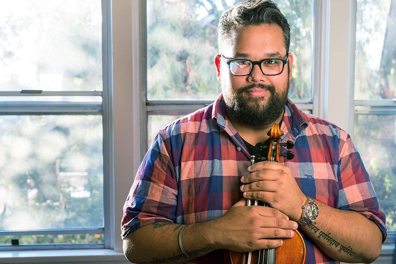 Robert Vijay Gupta, the Mark Houston Dalzell and James Dao-Dalzell first chair violin with the Los Angeles Philharmonic and founder and artistic director of Street Symphony, poses with his violin in his house in Los Angeles. Gupta and 24 other academics, activists, artists, scholars and scientists were named MacArthur fellows Thursday. The recipients will receive $625,000 over five years to use as they please. (Photo by John D. and Catherine T. MacArthur Foundation via AP)
