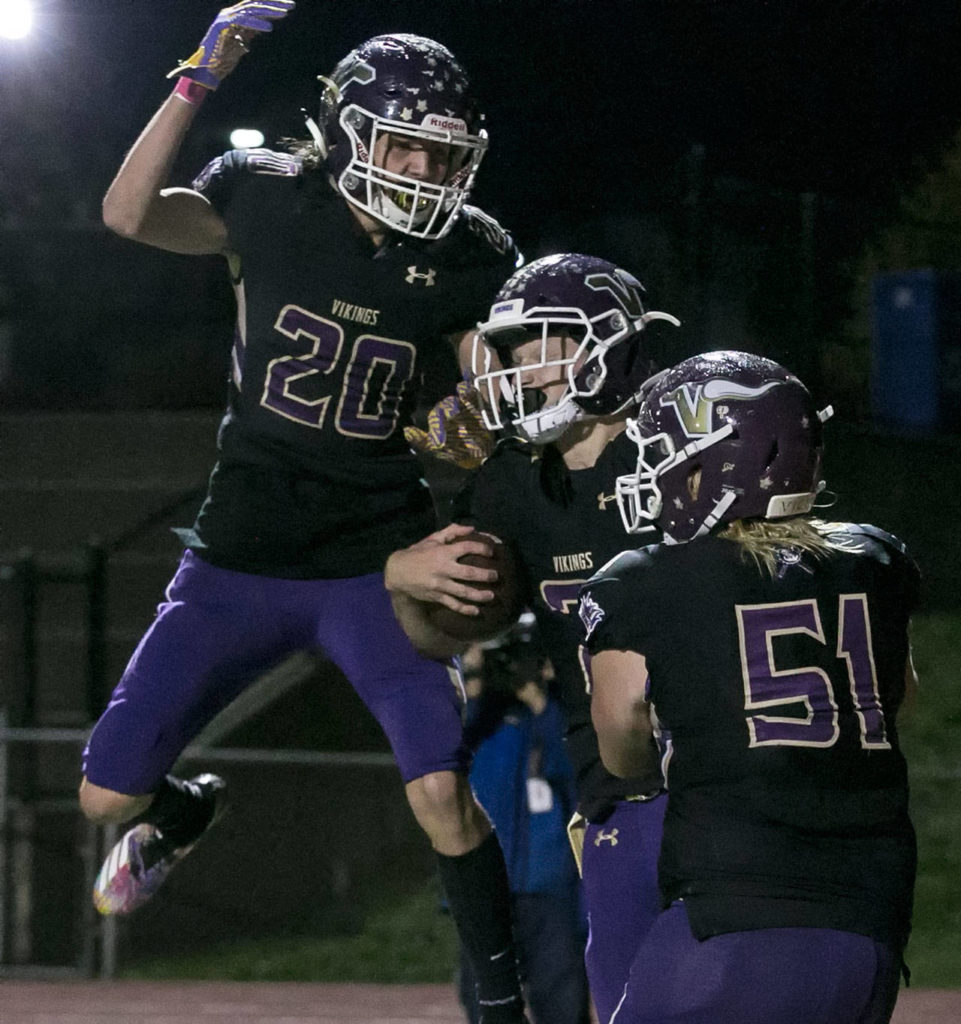 Lake Stevens’ Joe Gonzales (left) and Mason Gack (right) celebrate Jackson Grafe’s (center) touchdown. (Kevin Clark / The Herald)
