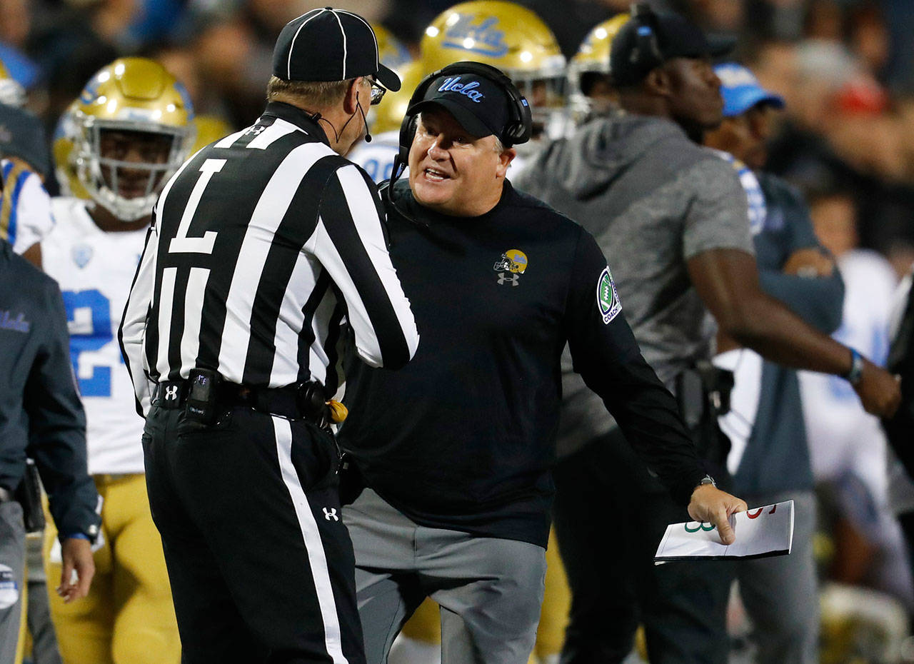 UCLA coach Chip Kelly argues a call with official Tim Messuri during the second half of a game against Colorado on Sept. 28, 2018, in Boulder, Colo. (AP Photo/David Zalubowski)