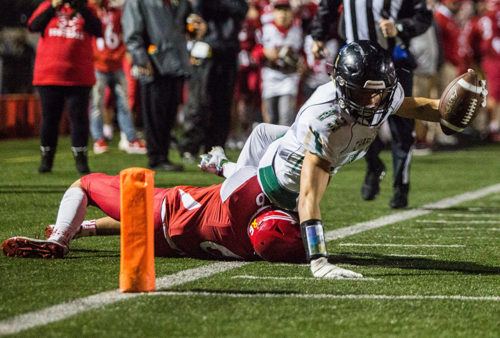 Marysville-Getchell’s Dylan Rice is tackled out of bounds as he reaches for the end zone during the game on Oct. 5 in Marysville. (Olivia Vanni / The Herald)
