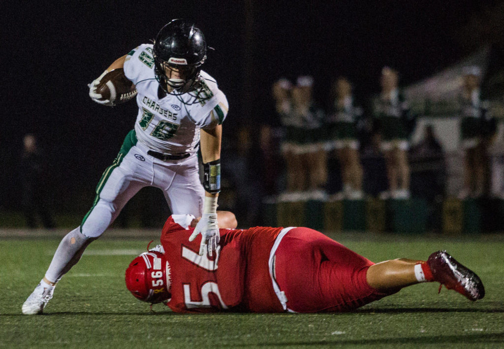 Marysville-Getchell’s Ryan King is tackled during the game on Oct. 5 in Marysville. (Olivia Vanni / The Herald)
