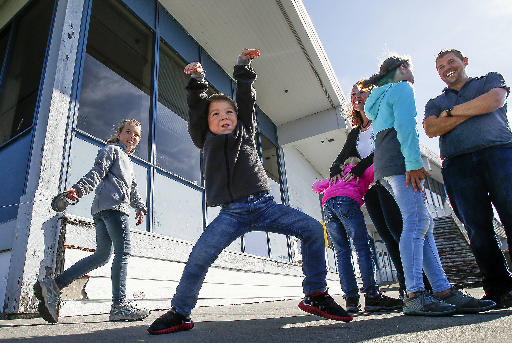 To the delight of the rest of his family, Caleb, 4, spontaneously begins to dance while on a walk near the Everett Yacht Club. (Dan Bates / The Herald)