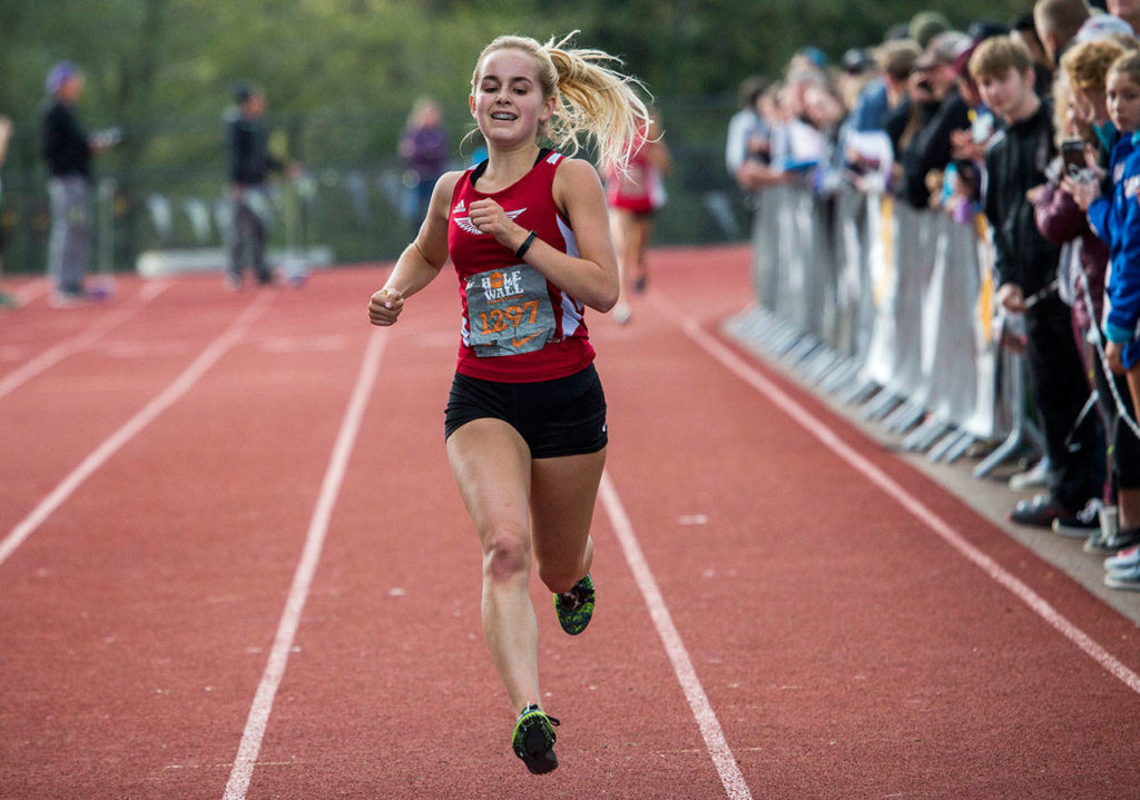 King’s junior Naomi Smith crosses the finish line Saturday during the Hole in the Wall Invitational at Lakewood High School in Arlington. (Olivia Vanni / The Herald)

