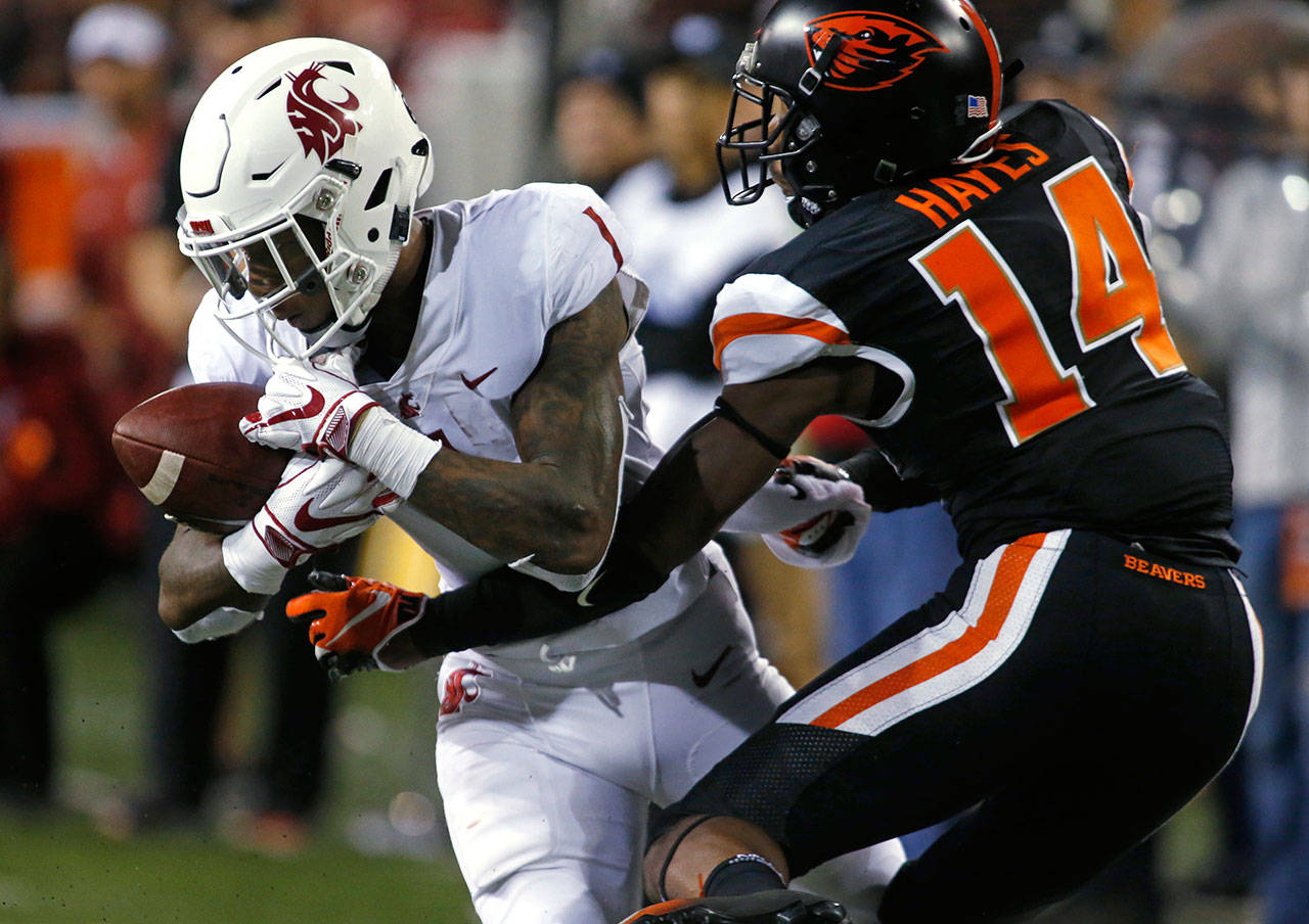 Washington State’s Tay Martin (1) makes a catch in front of Oregon State’s Kaleb Hayes during the fourth quarter of a game on Oct. 6, 2018, in Corvallis, Ore. (AP Photo/Timothy J. Gonzalez)