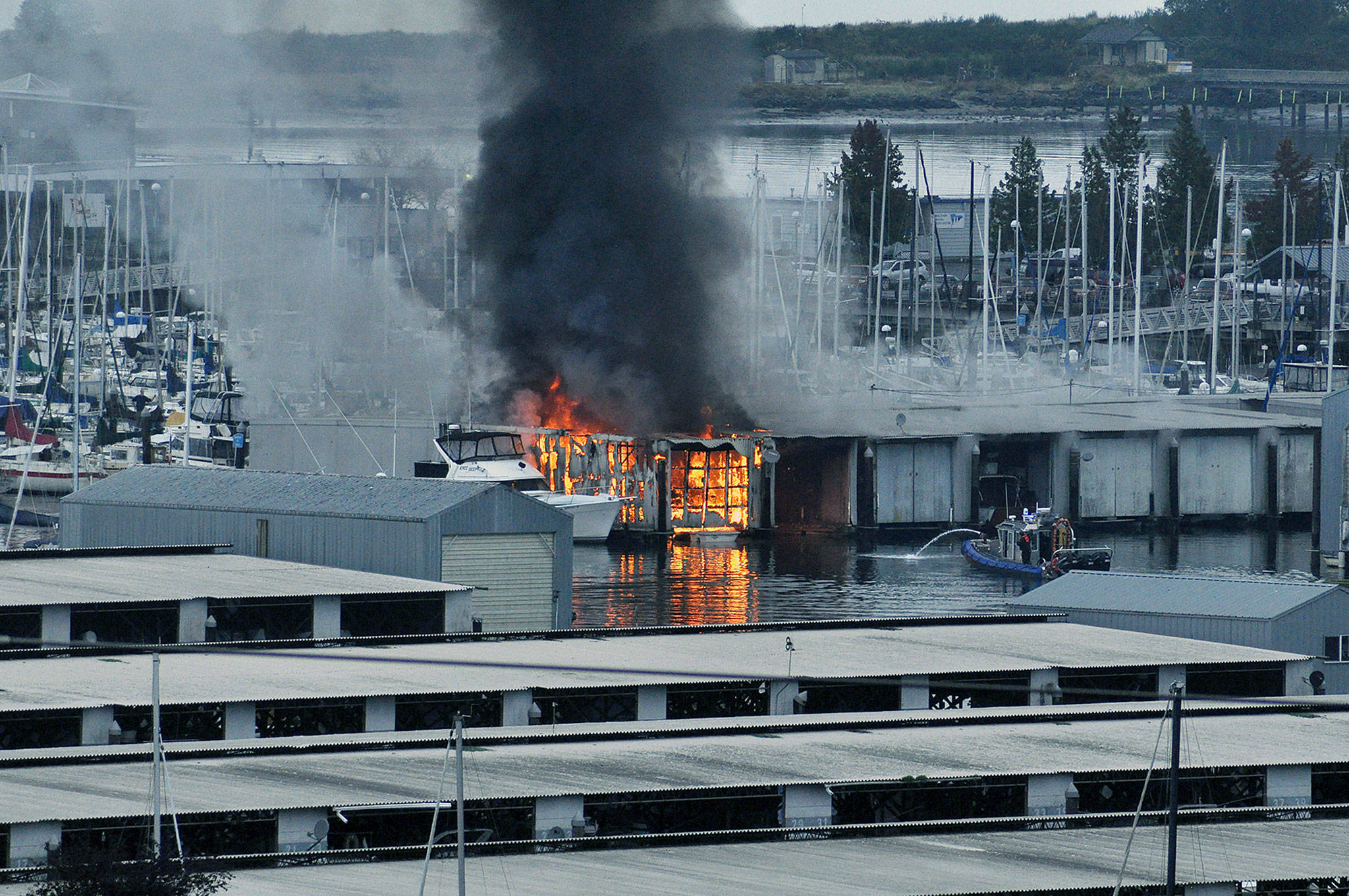 The fire in a boathouse and boat on the Everett waterfront Monday morning. (Sue Misao / The Herald)