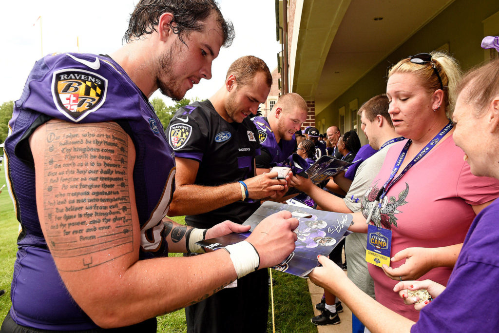 Baltimore Ravens lineman Randin Crecelius, a graduate of Cascade High School, signs autographs after a practice session. (Baltimore Ravens)
