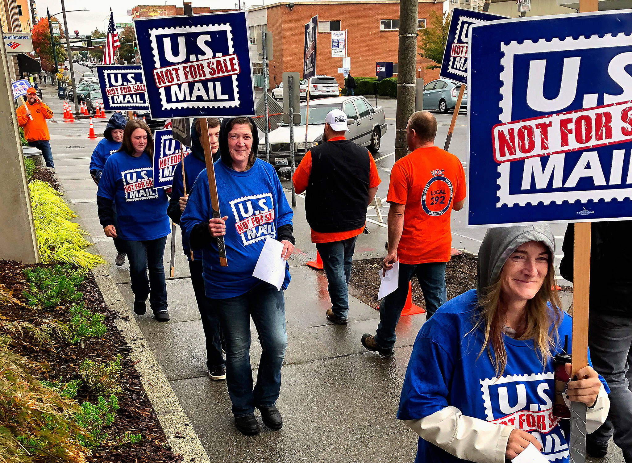 Postal workers and other supportive union members take part in an informational picket in downtown Everett Monday. They oppose possible privatization of the U.S. Postal Service, which is being explored by the Trump administration. (Photo Bob James)