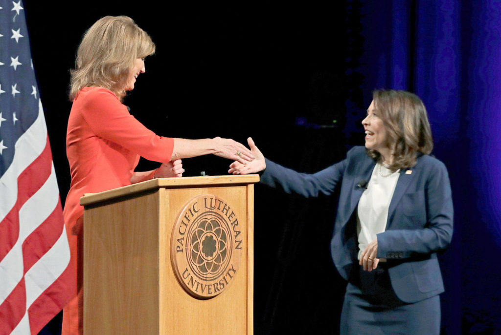 Sen. Maria Cantwell (right), D-Washington, shakes hands with her Republican challenger, Susan Hutchison, on Monday after a debate at Pacific Lutheran University in Tacoma. (AP Photo/Ted S. Warren) 
