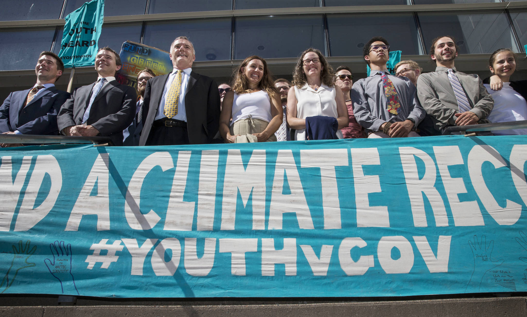 In this July 18 photo, lawyers and youth plaintiffs lineup behind a banner after a hearing before Federal District Court Judge Ann Aiken between lawyers for the Trump Administration and the so called Climate Kids in Federal Court in Eugene, Oregon The federal government has again asked a judge to suspend legal proceedings in the climate change lawsuit scheduled to go to trial in Oregon later this month. (Chris Pietsch/The Register-Guard via AP, File)