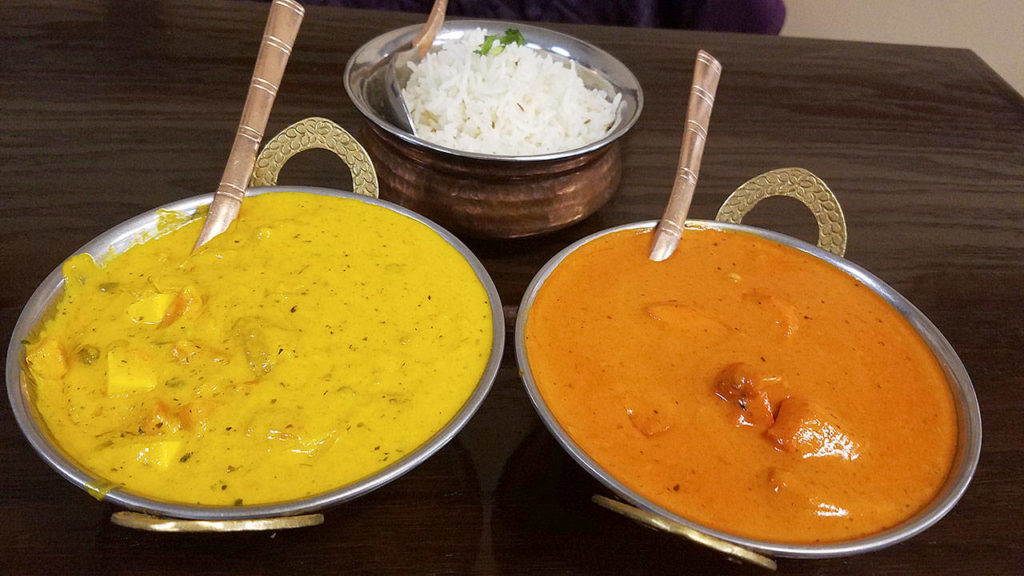 Entrees butter chicken on the right and Navrattan korma on the left from Everett’s Tasty Indian Bistro. (Sharon Salyer/The Herald)
