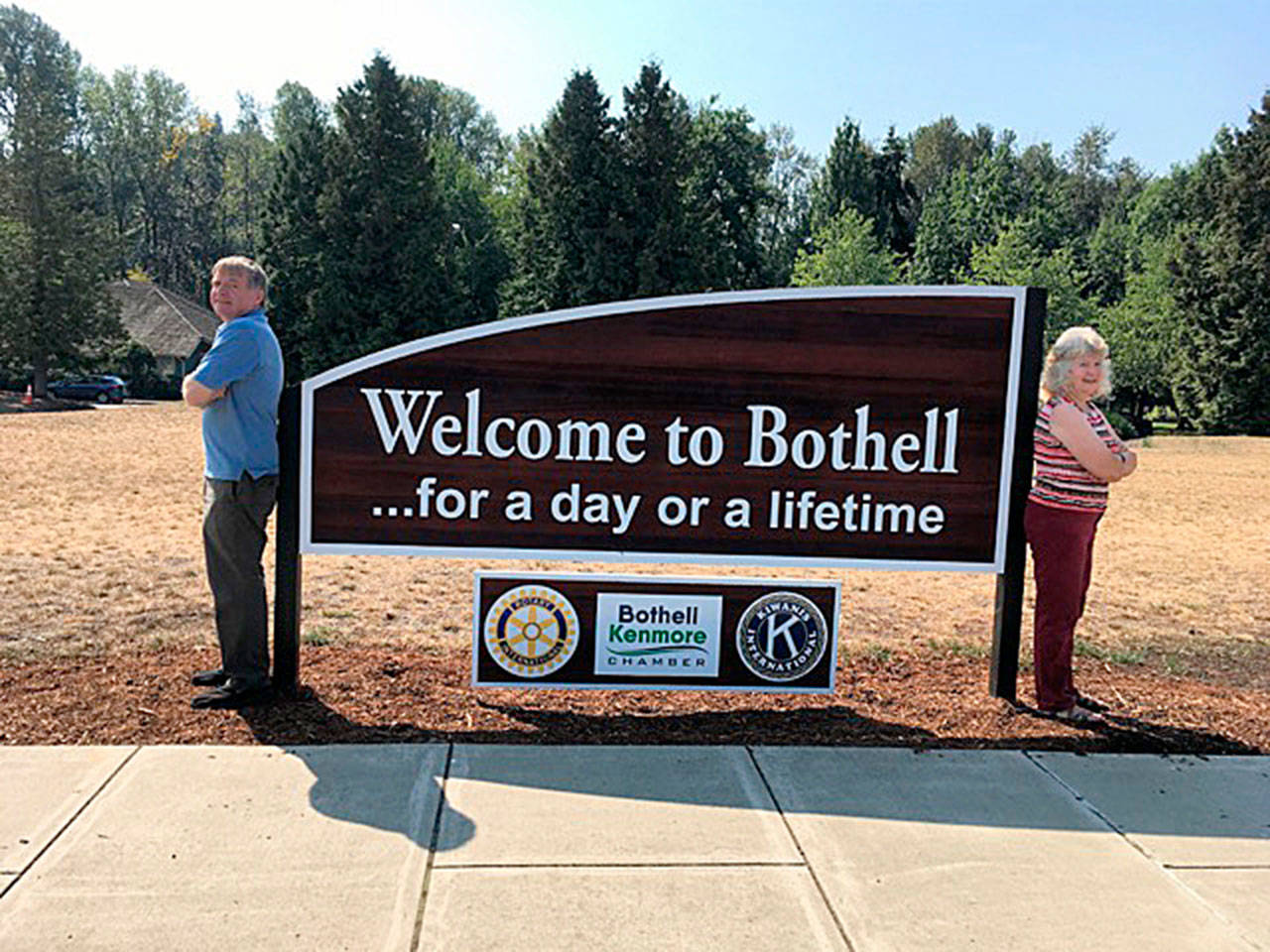 Richard Olson and Susan Gardner bookend the new sign. (Richard Olson)