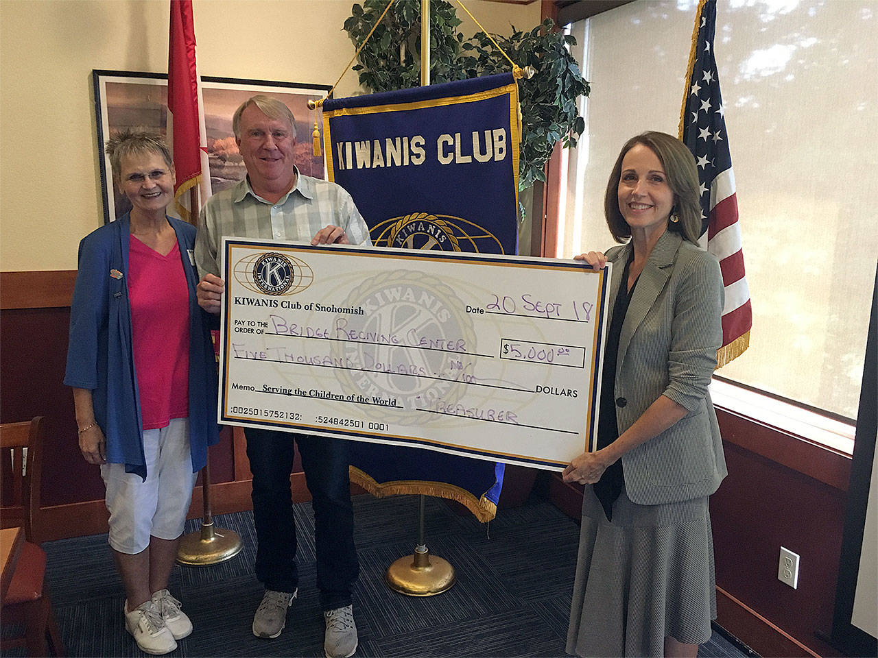 Kiwanis Club of Snohomish Incoming President Melody Dana (from left) presents a donation to Dan Hamer and Tracy Rubstello of Bridge Receiving Center. (Contributed photo)